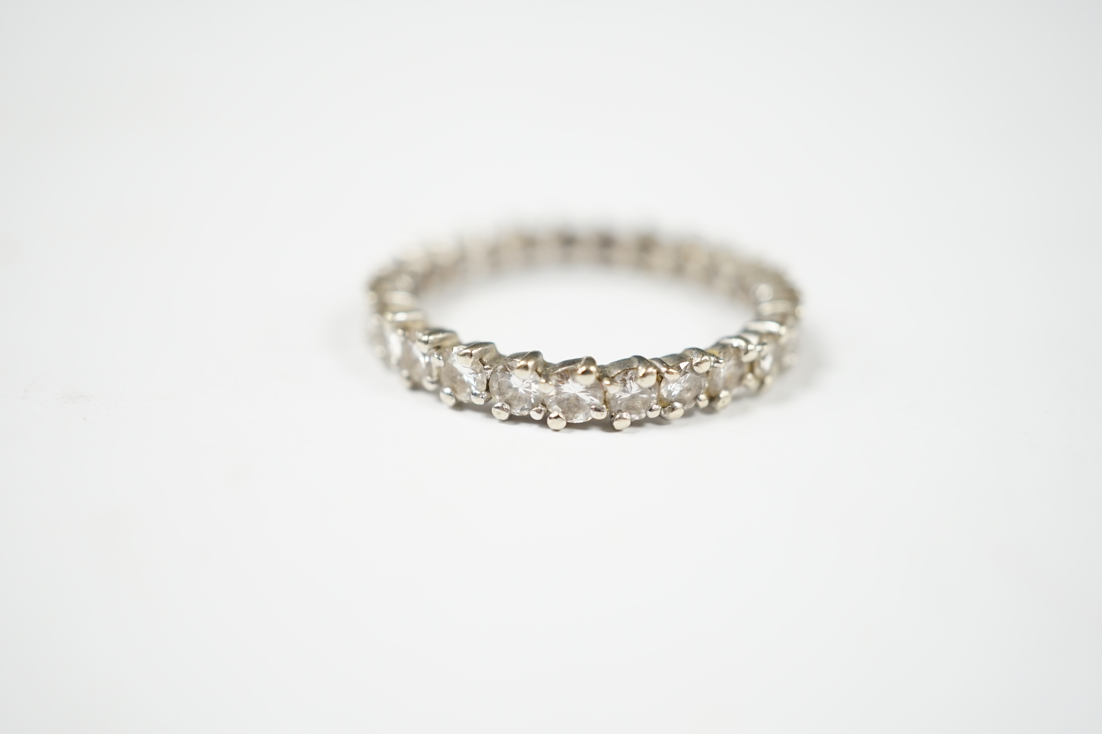 An early 20th century French 18k white gold and diamond set full eternity ring, size Q, gross weight 2.9 grams (stone missing). Condition - poor to fair